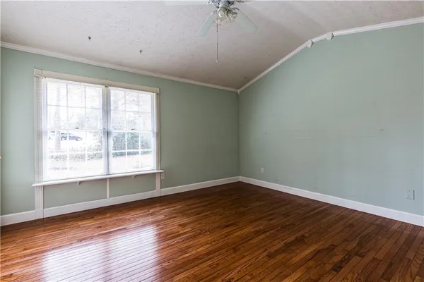 a spacious bathroom with a toilet a sink a mirror and a window