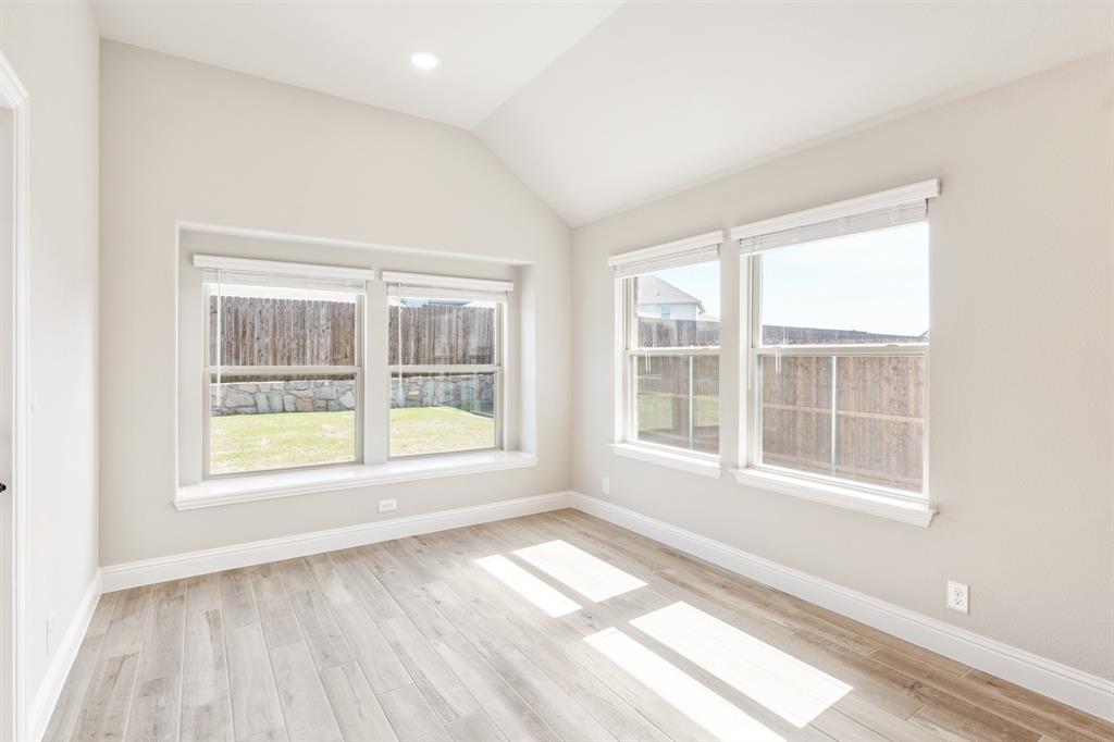 2016 Dundalk Lane Forney, TX 75126 - Photo 14 of 40 an empty room with wooden floor and windows