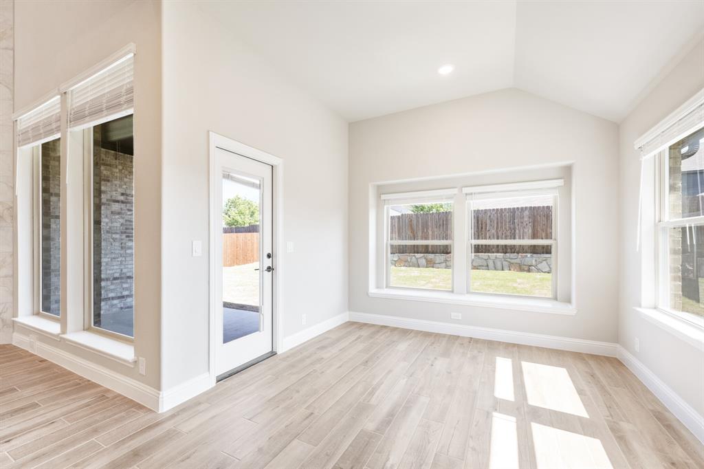 2016 Dundalk Lane Forney, TX 75126 - Photo 15 of 40 an empty room with wooden floor and windows