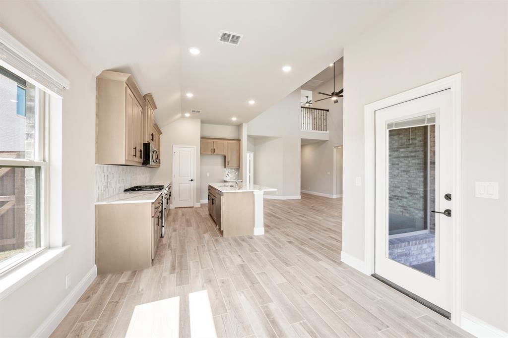2016 Dundalk Lane Forney, TX 75126 - Photo 16 of 40 a view of a kitchen with kitchen island wooden floor center island and stainless steel appliances