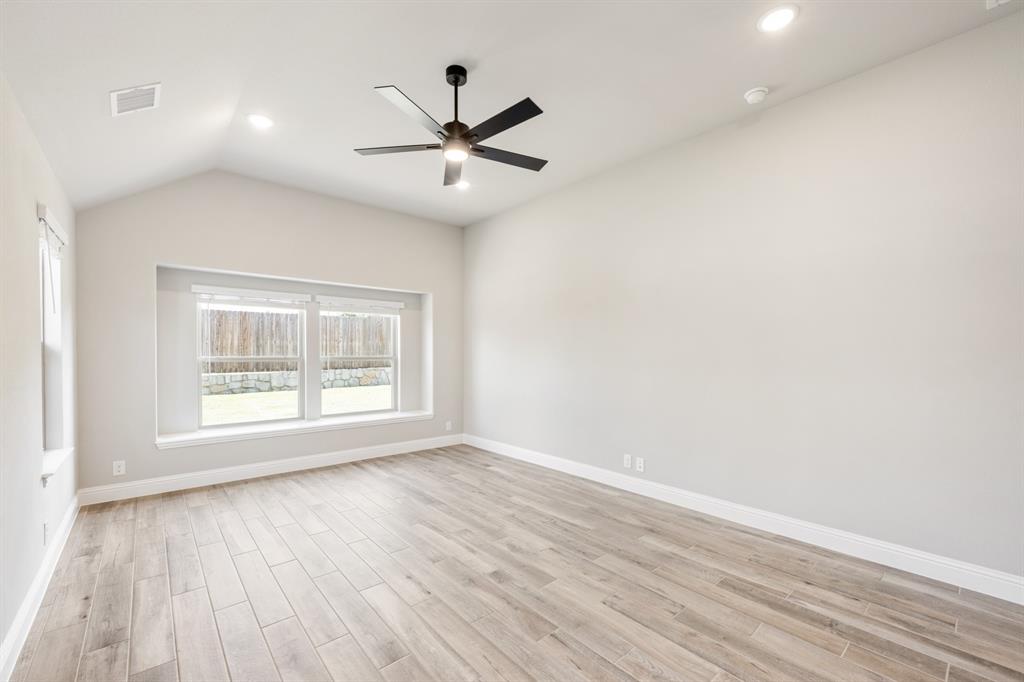 2016 Dundalk Lane Forney, TX 75126 - Photo 21 of 40 an empty room with wooden floor fan and windows