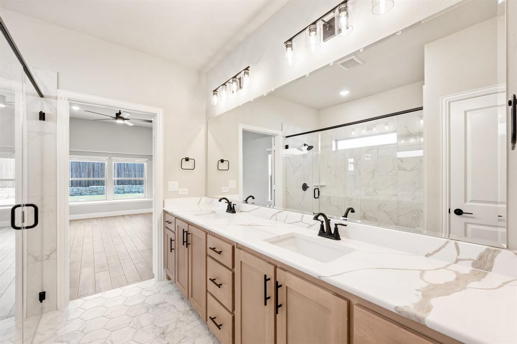 2016 Dundalk Lane Forney, TX 75126 - Photo 23 of 40 a bathroom with double vanity sinks and a mirror