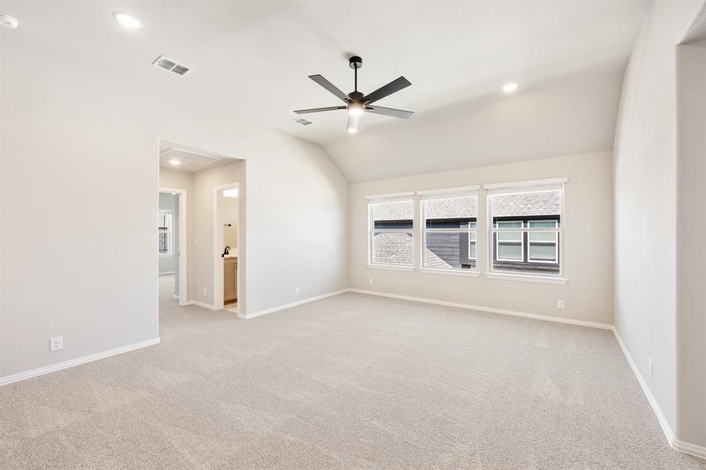 2016 Dundalk Lane Forney, TX 75126 - Photo 26 of 40 an empty room with a ceiling fan and windows