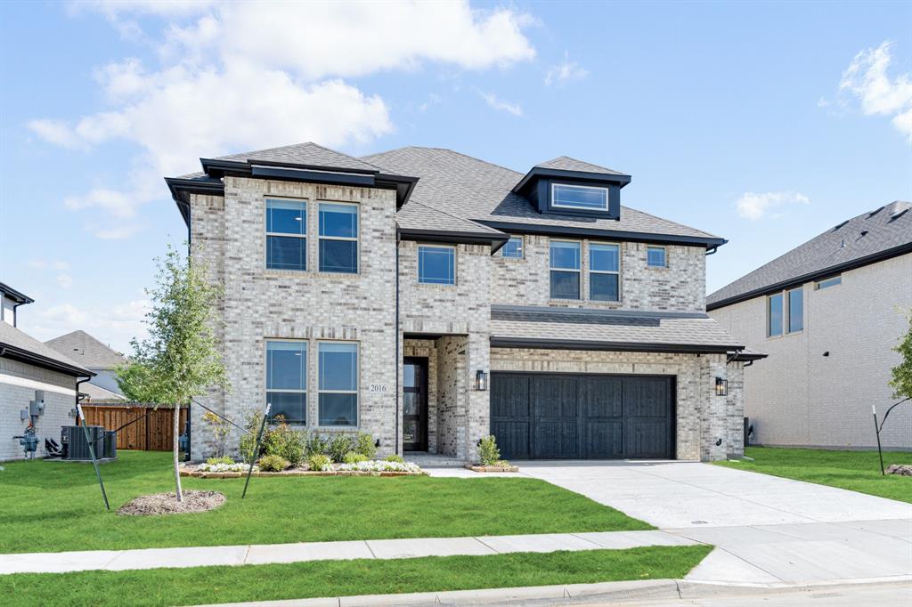 2016 Dundalk Lane Forney, TX 75126 - Photo 3 of 40 a front view of a house with a yard
