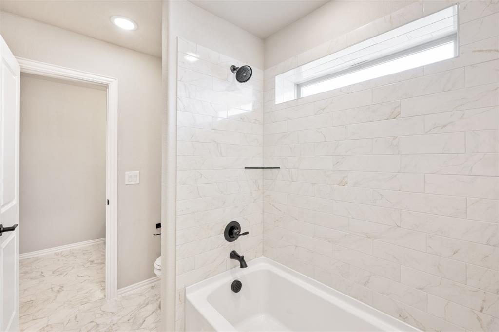 2016 Dundalk Lane Forney, TX 75126 - Photo 34 of 40 a bathroom with a bathtub