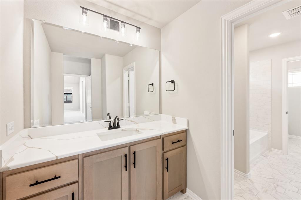 2016 Dundalk Lane Forney, TX 75126 - Photo 35 of 40 a bathroom with a sink and a mirror