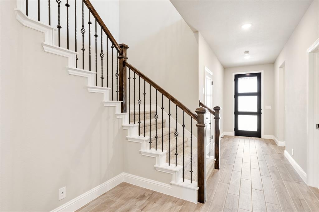 2016 Dundalk Lane Forney, TX 75126 - Photo 5 of 40 a view of a hallway with wooden floor and staircase