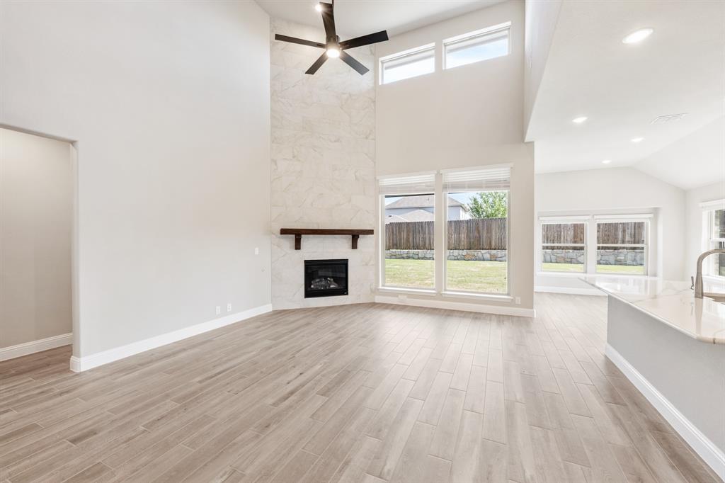 2016 Dundalk Lane Forney, TX 75126 - Photo 9 of 40 a view of empty room with wooden floor and fireplace