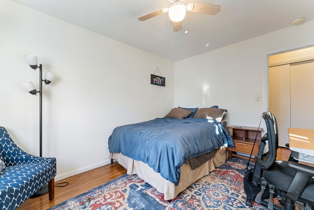 425 South Huntington Avenue, Unit 6 Boston, MA 02130 - Photo 12 of 19 a bedroom with a bed and a chandelier