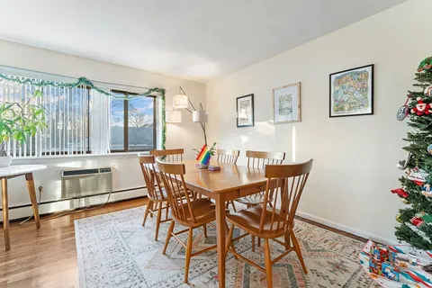 a dining room with furniture and wooden floor
