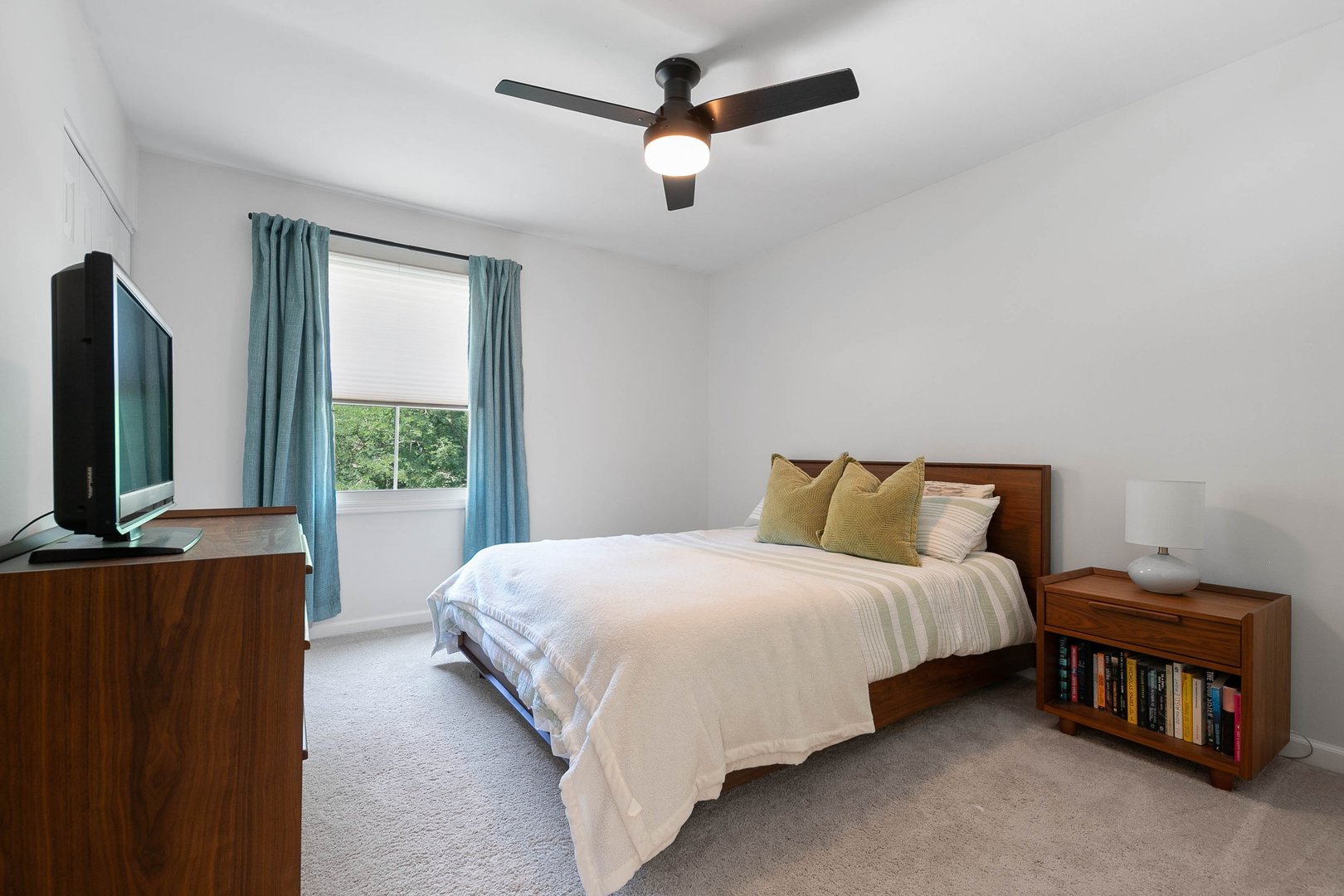 16 Redstart Road Naperville, IL 60565 - Photo 18 of 23 a bedroom with a bed a flat screen tv and a window