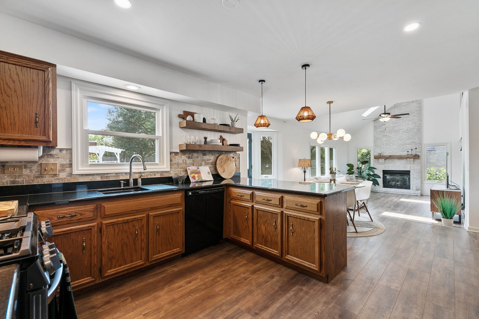 16 Redstart Road Naperville, IL 60565 - Photo 7 of 23 a kitchen with stainless steel appliances granite countertop a sink a stove and a wooden floors