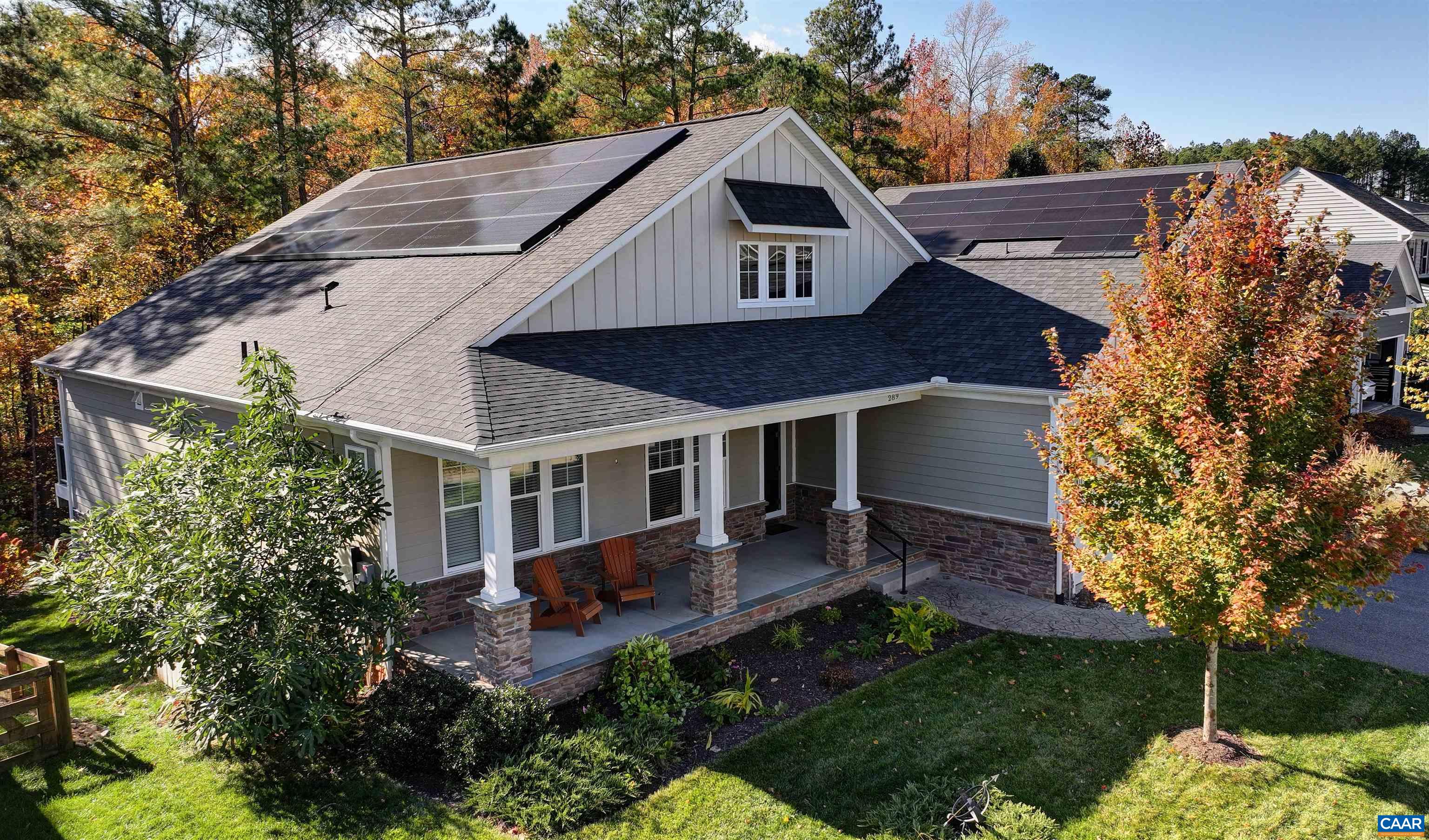 a aerial view of a house with a yard and potted plants