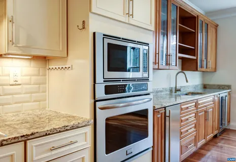 an empty room with a ceiling fan and windows