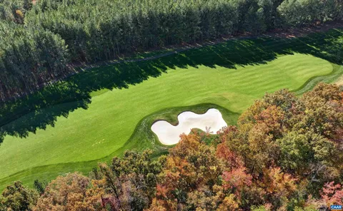 a view of a livingroom with wooden floor and a fireplace