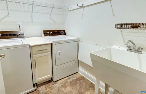 a view of empty room with kitchen