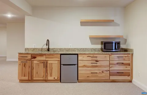 a view of an empty room with wooden shelves