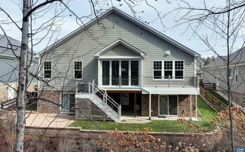 a view of house with roof deck and furniture