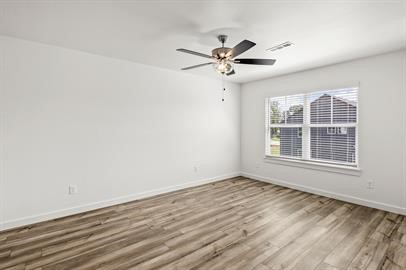 547 West Pickens Road Pea Ridge, AR 72751 - Photo 12 of 17 Unfurnished room featuring wood finished floors and a ceiling fan