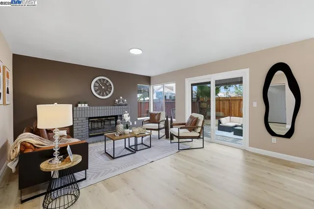 a living room with furniture a rug and a fireplace
