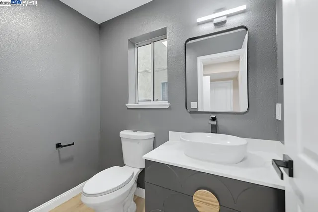 a bathroom with a toilet sink and mirror
