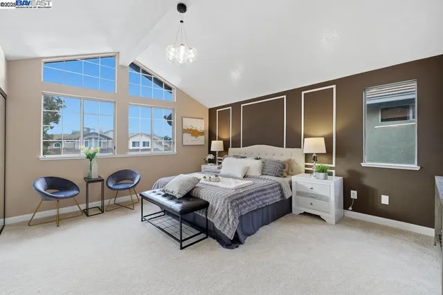 a spacious bedroom with a bed and window