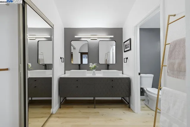 a bathroom with a bathtub sink and mirror