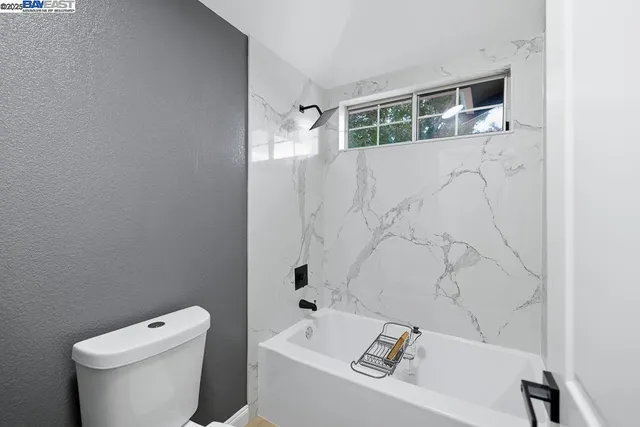 a bathroom with a bathtub and toilet