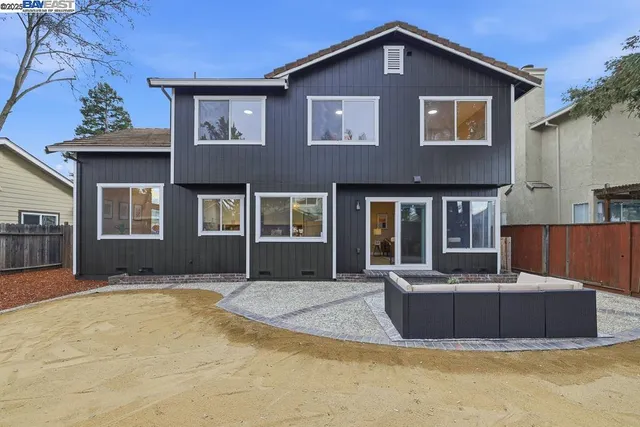a front view of a house with yard outdoor seating and barbeque oven
