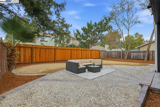 a backyard of a house with table and chairs