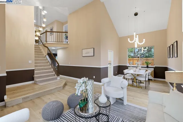a living room with furniture and a chandelier