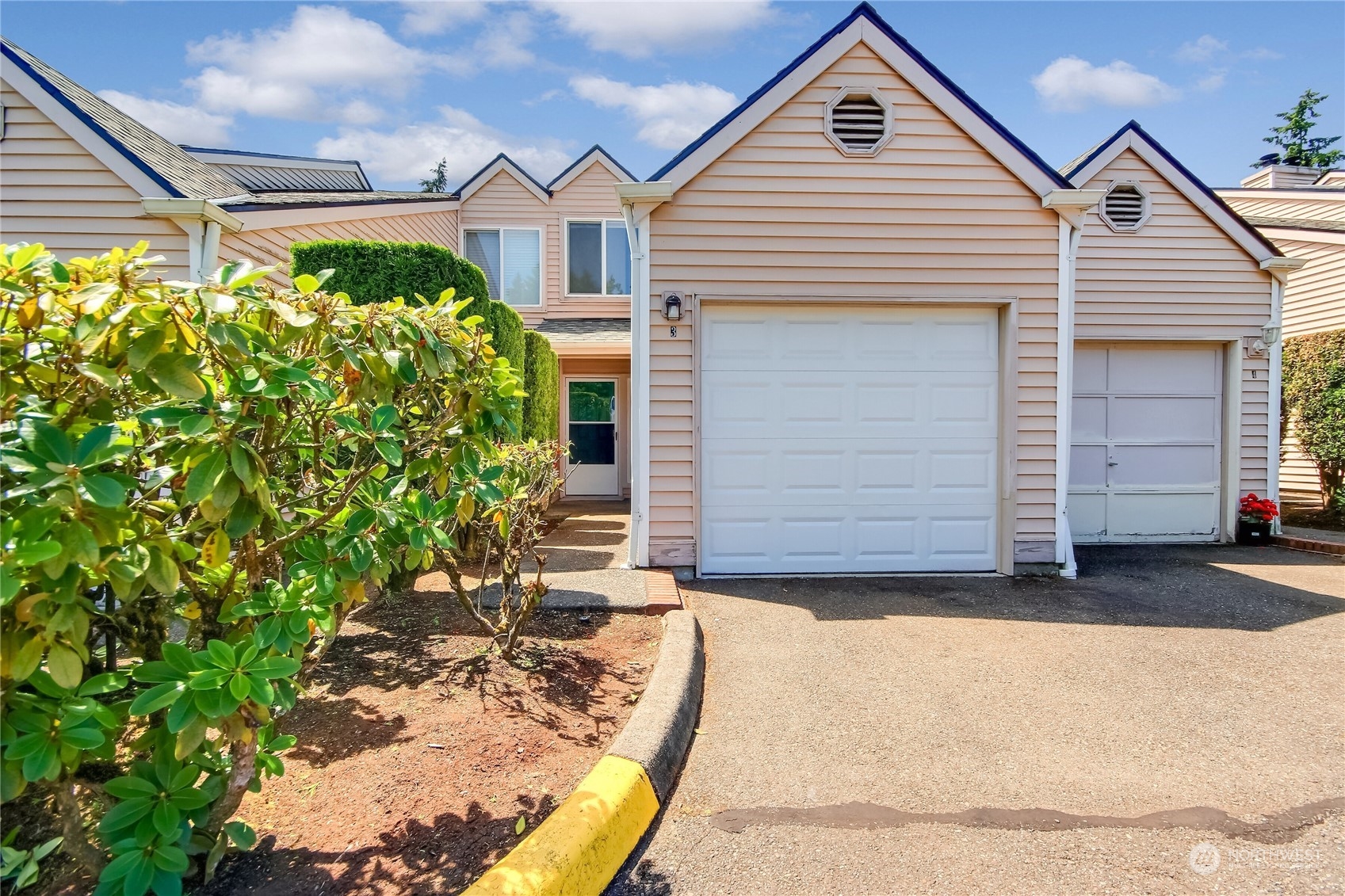 1825 South 330th Street, Unit E3 Federal Way, WA 98003 - Photo 1 of 26 a front view of a house with a yard and garage