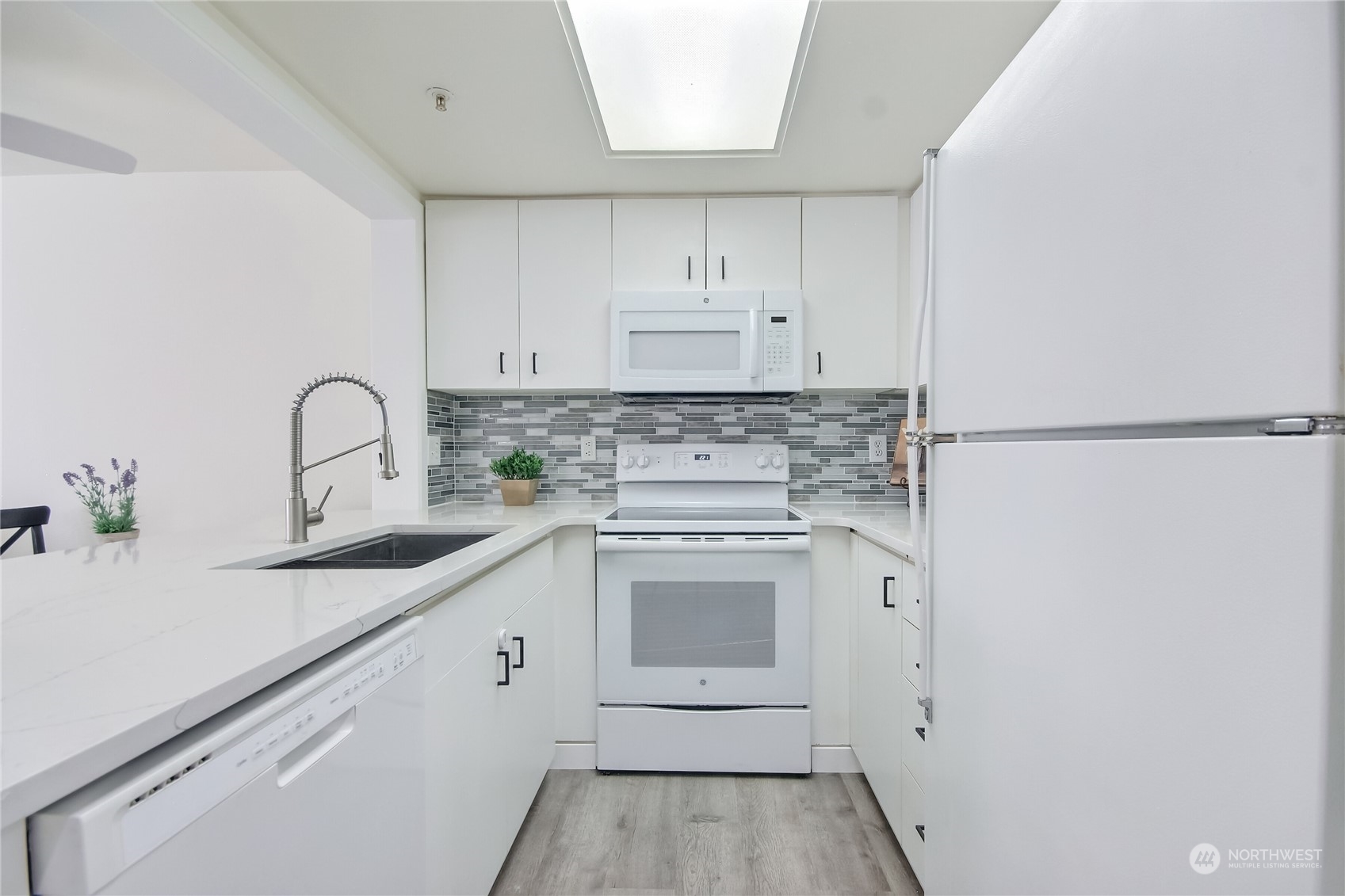 1825 South 330th Street, Unit E3 Federal Way, WA 98003 - Photo 5 of 26 a kitchen with a sink stove and cabinets