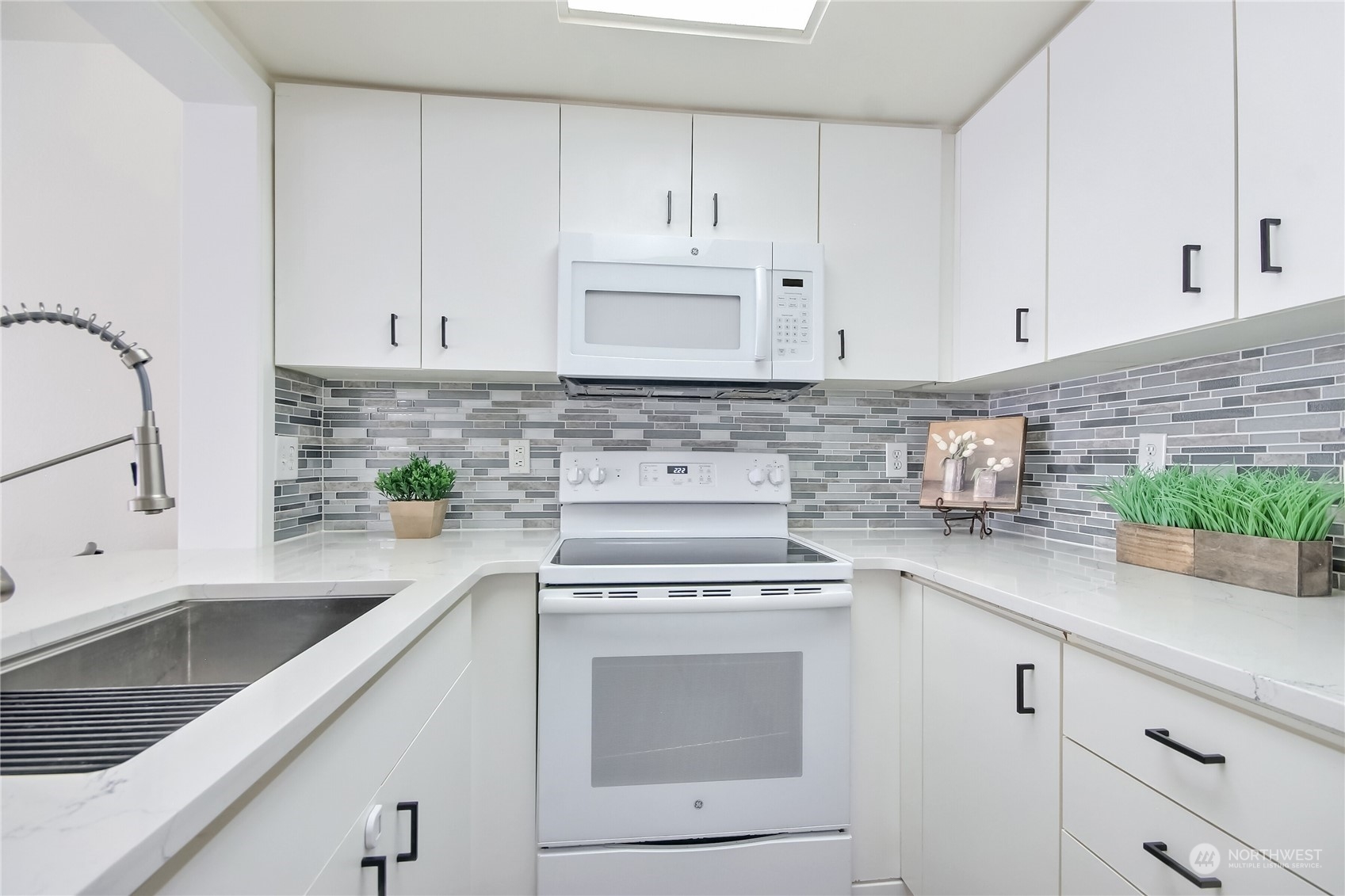 1825 South 330th Street, Unit E3 Federal Way, WA 98003 - Photo 7 of 26 a kitchen with cabinets appliances a sink and a counter top