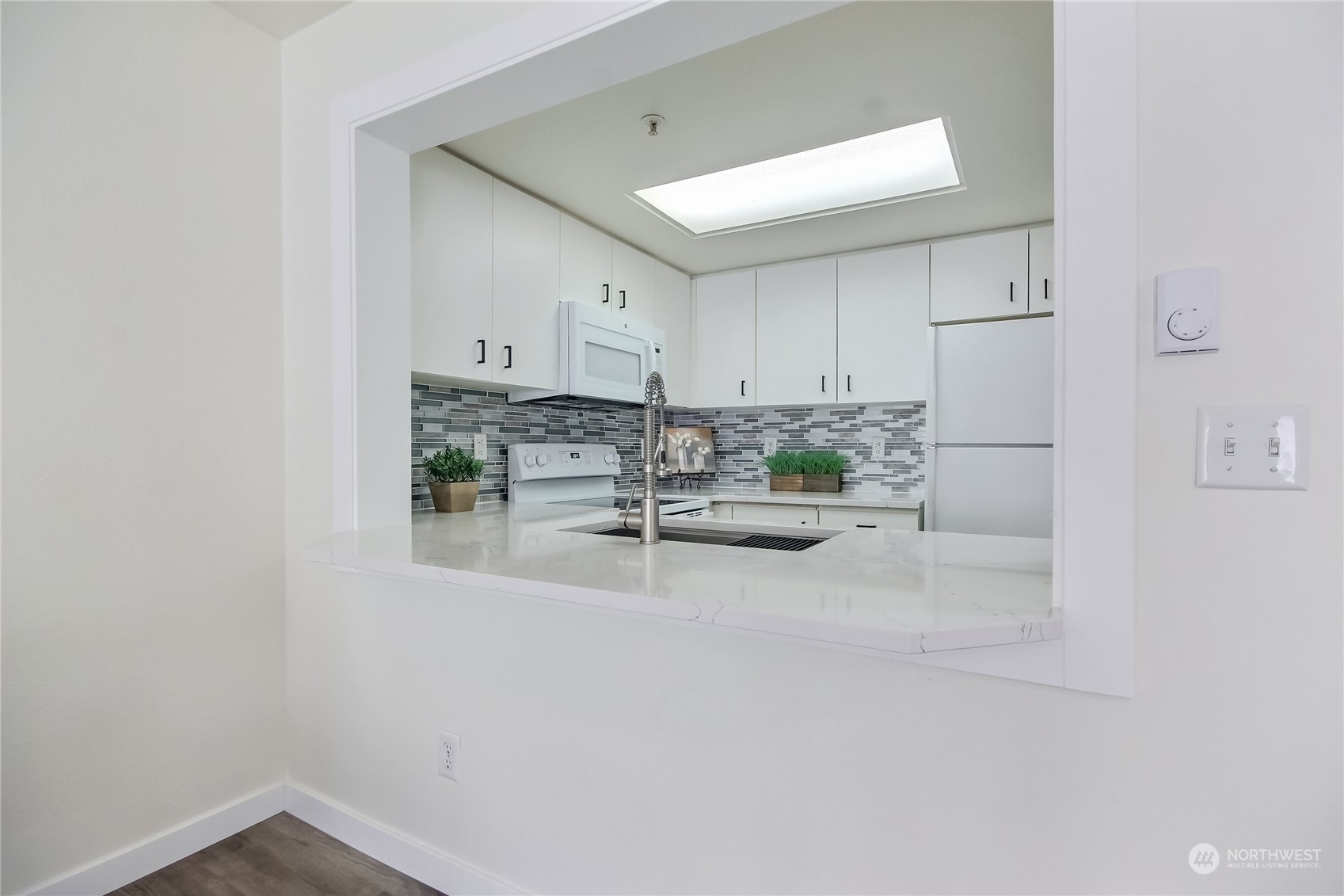 1825 South 330th Street, Unit E3 Federal Way, WA 98003 - Photo 8 of 26 a room with stainless steel appliances white cabinets and wooden floor