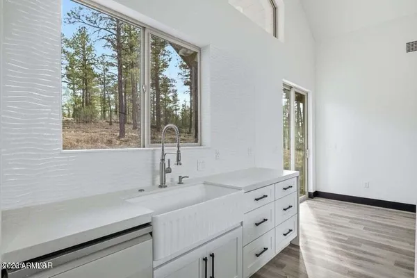 a kitchen with stainless steel appliances granite countertop a stove a refrigerator and a microwave