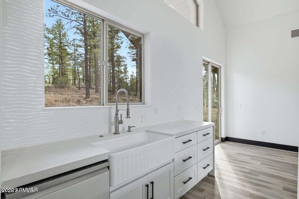 2381 West Bench Road Show Low, AZ 85901 - Photo 14 of 45 a bathroom with a sink and a large mirror next to a window
