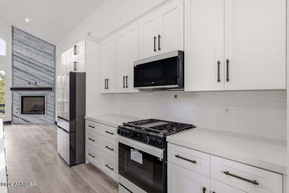 2381 West Bench Road Show Low, AZ 85901 - Photo 15 of 45 a kitchen with stainless steel appliances granite countertop a stove a refrigerator and a microwave