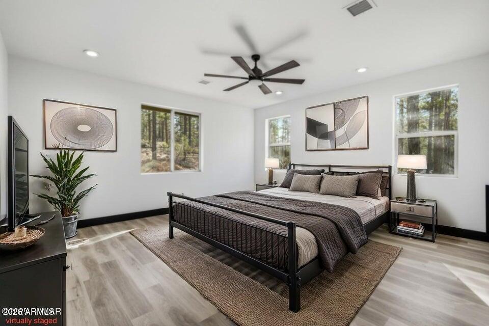 2381 West Bench Road Show Low, AZ 85901 - Photo 18 of 45 a bedroom with a large bed and a window