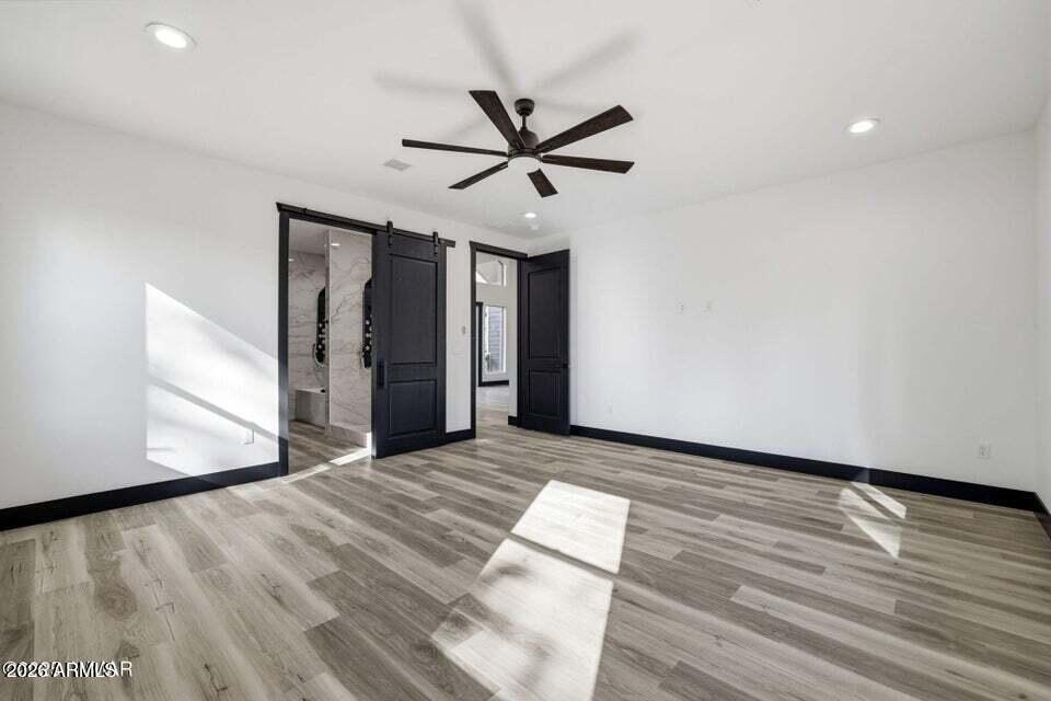 2381 West Bench Road Show Low, AZ 85901 - Photo 19 of 45 a view of an empty room with wooden floor and a ceiling fan