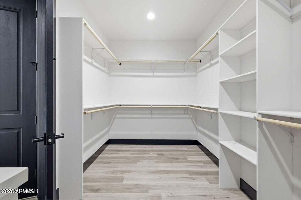 2381 West Bench Road Show Low, AZ 85901 - Photo 22 of 45 a view of walk in closet with empty racks