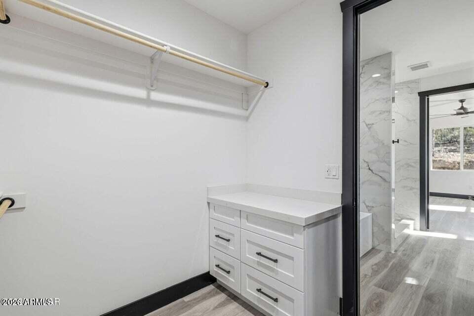 2381 West Bench Road Show Low, AZ 85901 - Photo 23 of 45 a view of walk in closet with empty racks