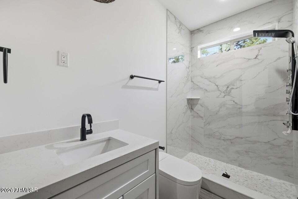 2381 West Bench Road Show Low, AZ 85901 - Photo 25 of 45 a bathroom with a sink a toilet and shower