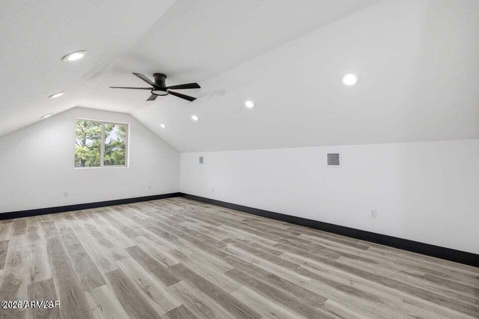 2381 West Bench Road Show Low, AZ 85901 - Photo 29 of 45 an empty room with wooden floor and windows