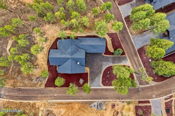 an aerial view of a house with garden space and street view