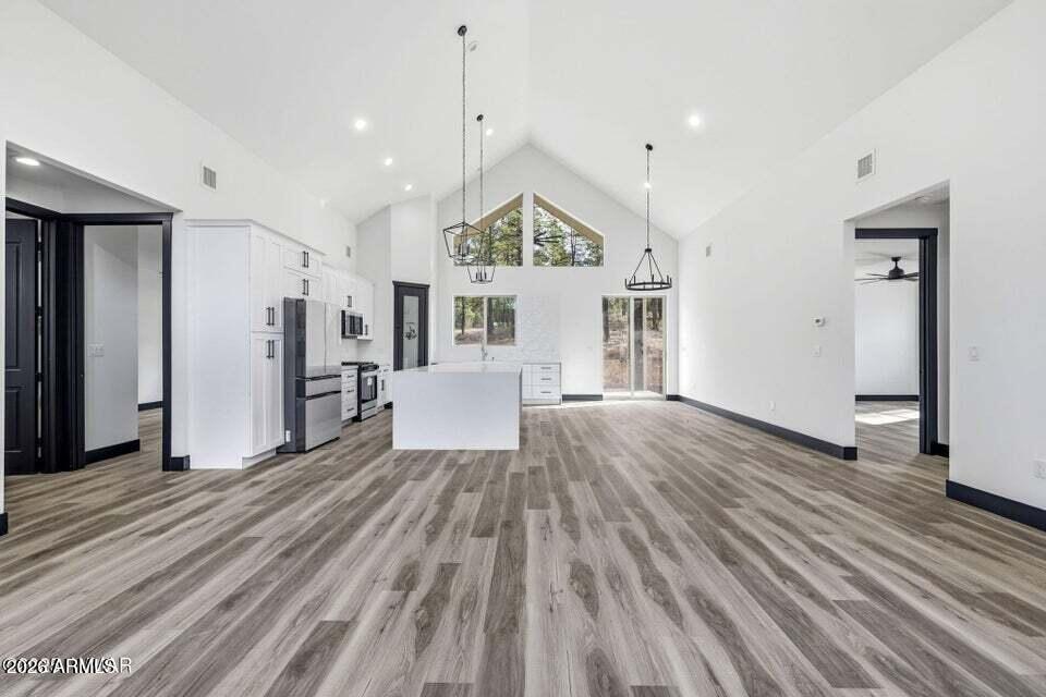 2381 West Bench Road Show Low, AZ 85901 - Photo 7 of 45 a view of a room with wooden floor white walls and windows