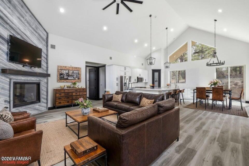 2381 West Bench Road Show Low, AZ 85901 - Photo 9 of 45 a living room with furniture a flat screen tv and a fireplace