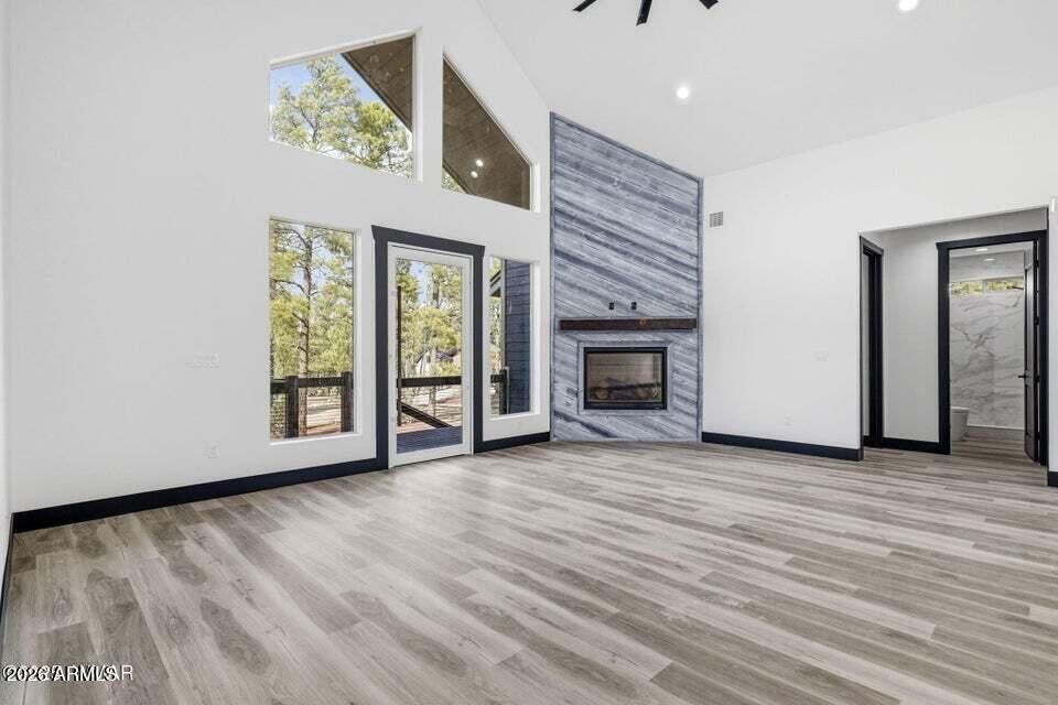 2381 West Bench Road Show Low, AZ 85901 - Photo 10 of 45 a view of an empty room with a window and fireplace