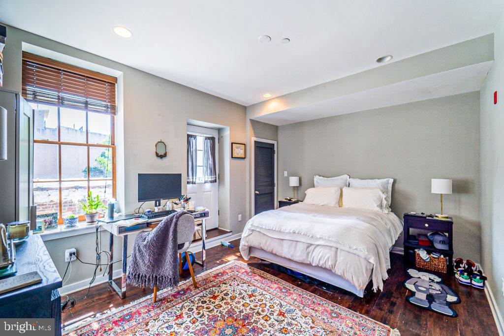 19 North 3rd Street Philadelphia, PA 19106 - Photo 12 of 14 a bedroom with a bed wooden floor and a desk