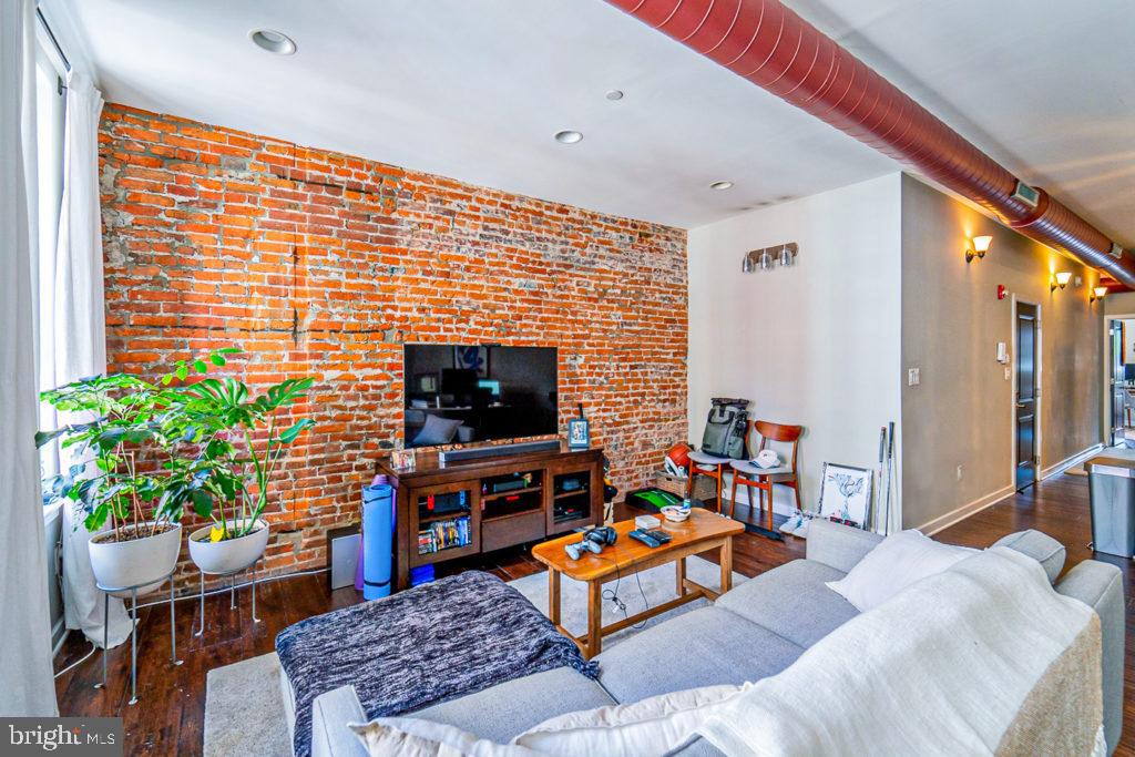 19 North 3rd Street Philadelphia, PA 19106 - Photo 3 of 14 a living room with furniture a flat screen tv and a potted plant